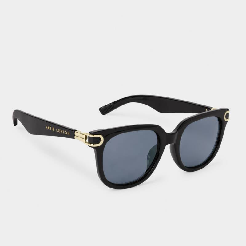 Black sunglasses with gold accents on a white background